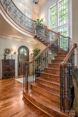 a view of entryway and hall with wooden floor