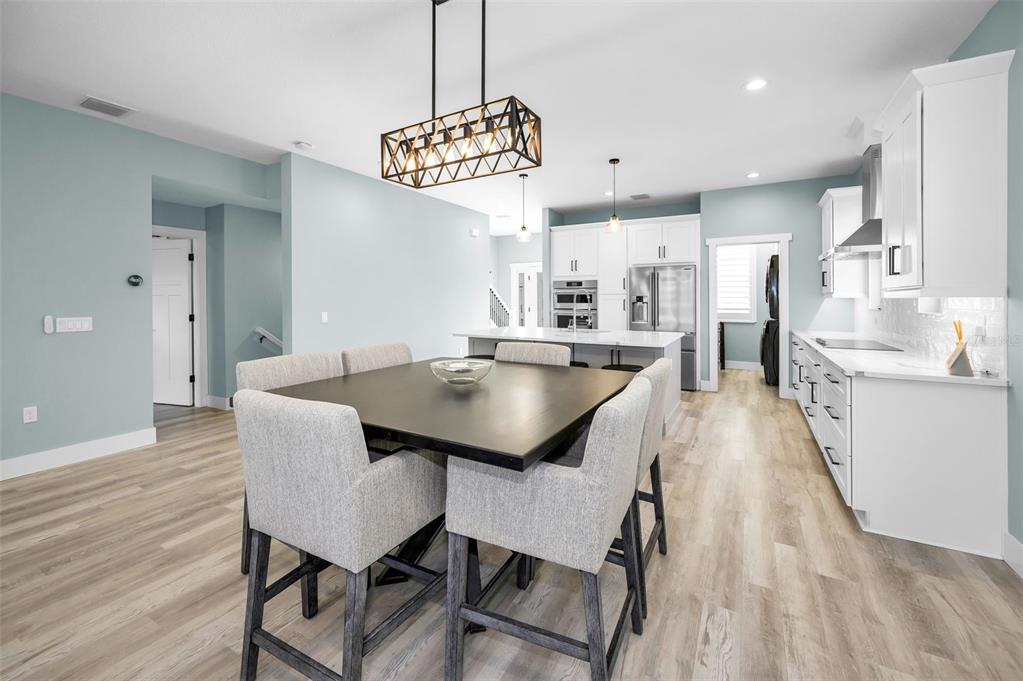 5650 Egrets Place New Port Richey, FL 34652 - Photo 19 of 73 a view of a dining room with furniture and wooden floor
