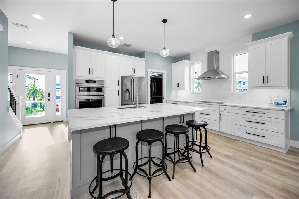 5650 Egrets Place New Port Richey, FL 34652 - Photo 21 of 73 a kitchen with stainless steel appliances a table chairs refrigerator and microwave