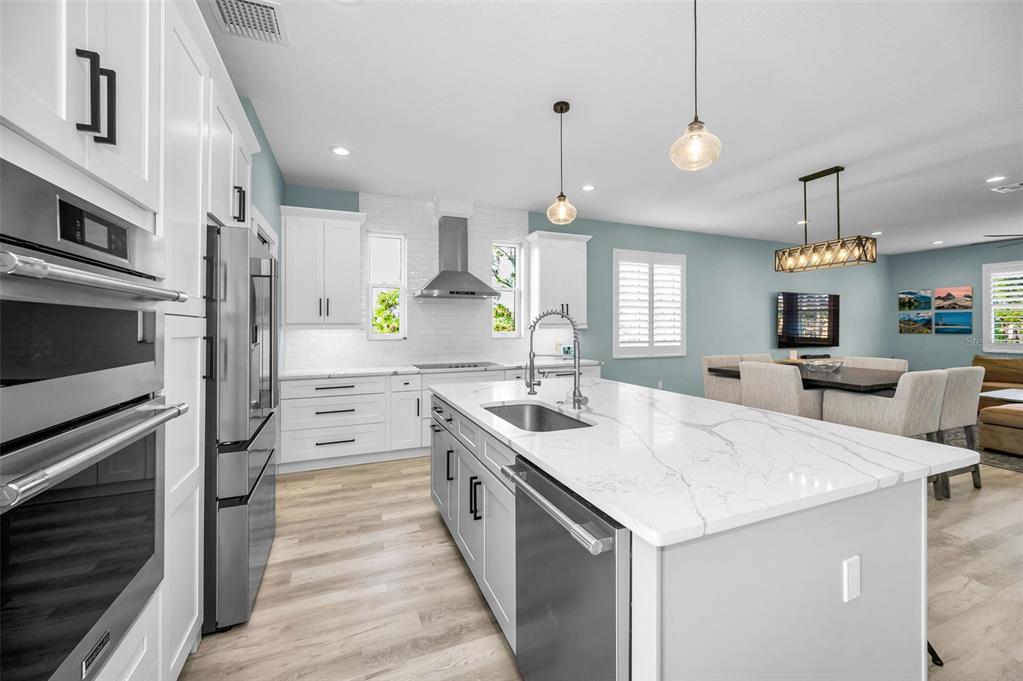 5650 Egrets Place New Port Richey, FL 34652 - Photo 26 of 73 a large kitchen with cabinets a sink and stainless steel appliances