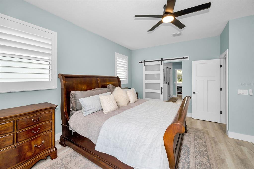 5650 Egrets Place New Port Richey, FL 34652 - Photo 32 of 73 a bedroom with a bed a chandelier and a closet