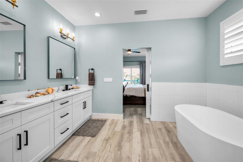 5650 Egrets Place New Port Richey, FL 34652 - Photo 37 of 73 a en suite spacious bathroom with a double vanity sink and a mirror