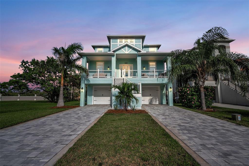5650 Egrets Place New Port Richey, FL 34652 - Photo 4 of 73 a front view of a house with a yard and potted plants