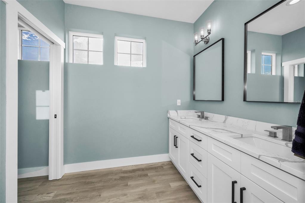 5650 Egrets Place New Port Richey, FL 34652 - Photo 49 of 73 a bathroom with a double vanity sink and mirror