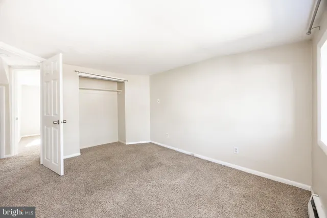 a view of an empty room and closet area