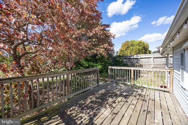 a balcony with wooden floor and fence