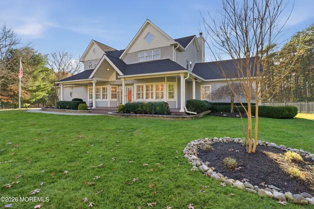 a front view of a house with a yard and trees