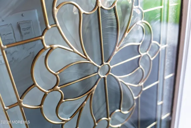 a bedroom with a bed and a flat tv screen on dresser