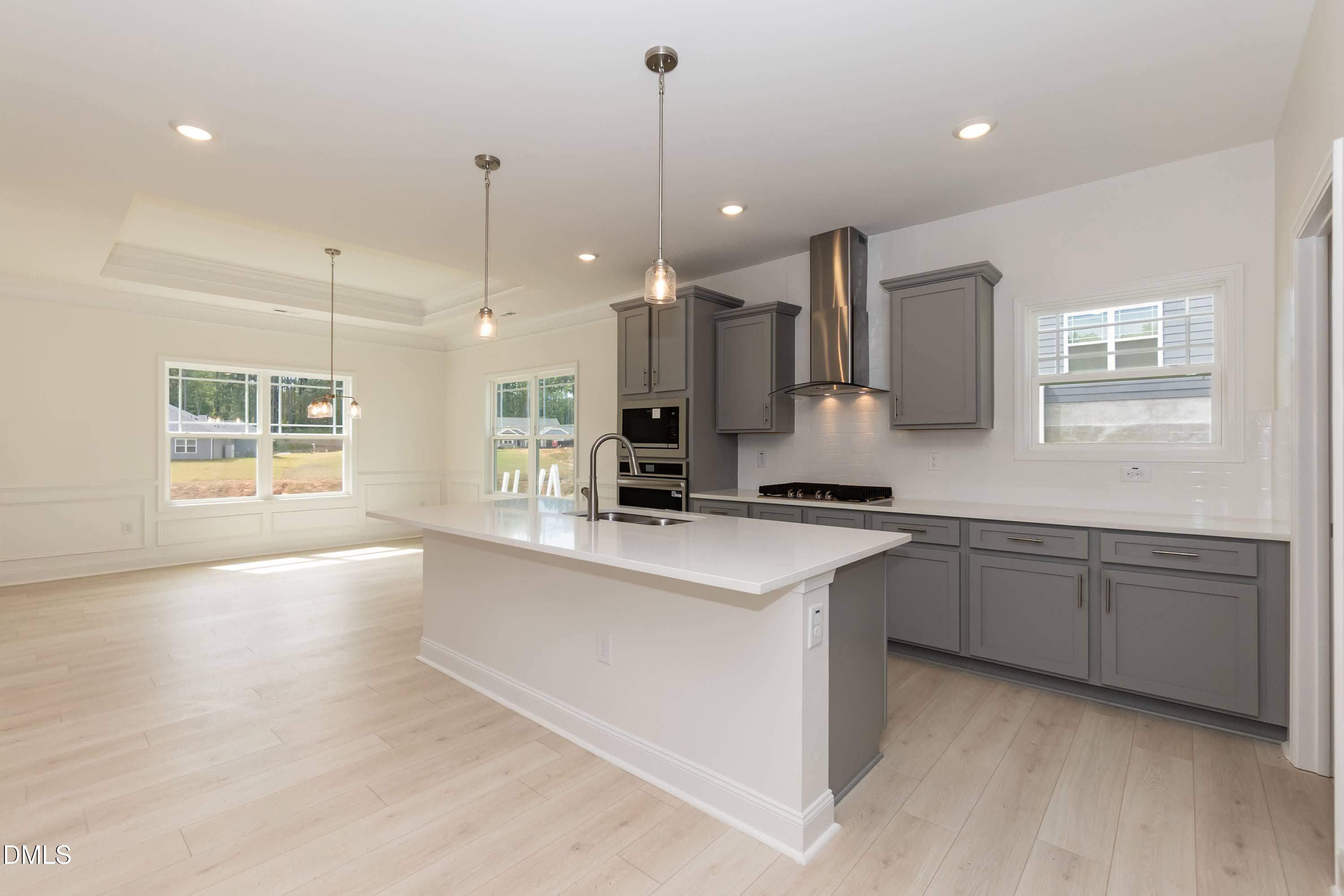 254 Galway Road Lillington, NC 27546 - Photo 9 of 35 a large kitchen with kitchen island a sink granite counter tops and a living room view
