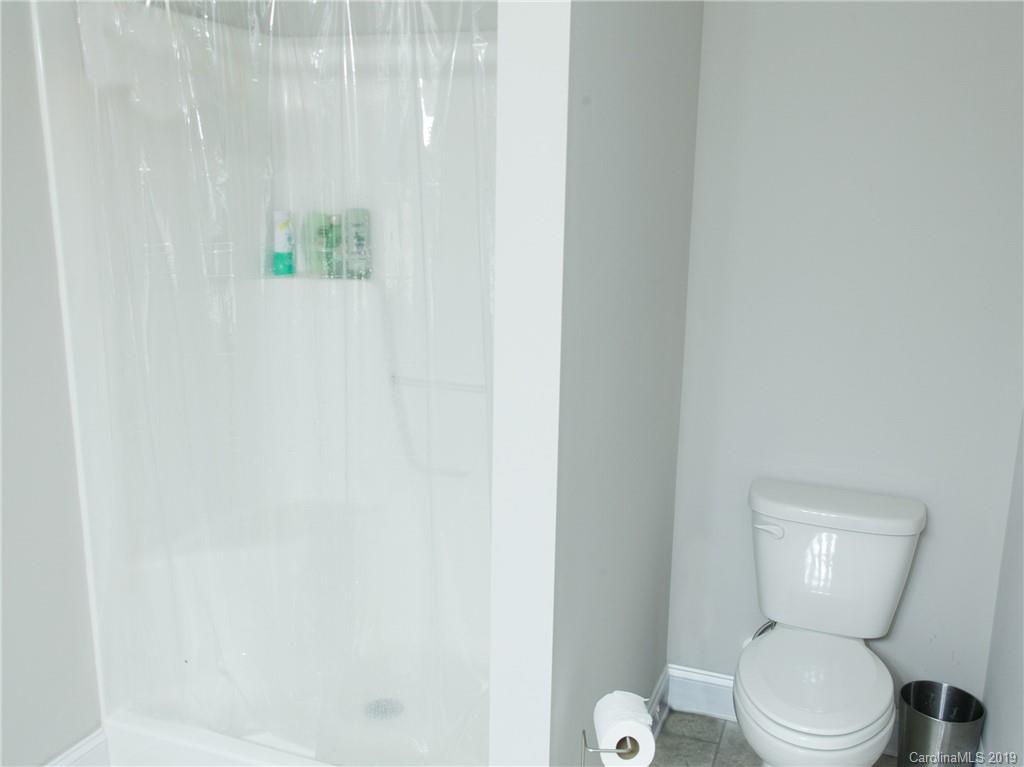 3018 Ranger Road, Unit 2B Clover, SC 29710 - Photo 16 of 23 a white toilet sitting next to a shower curtain
