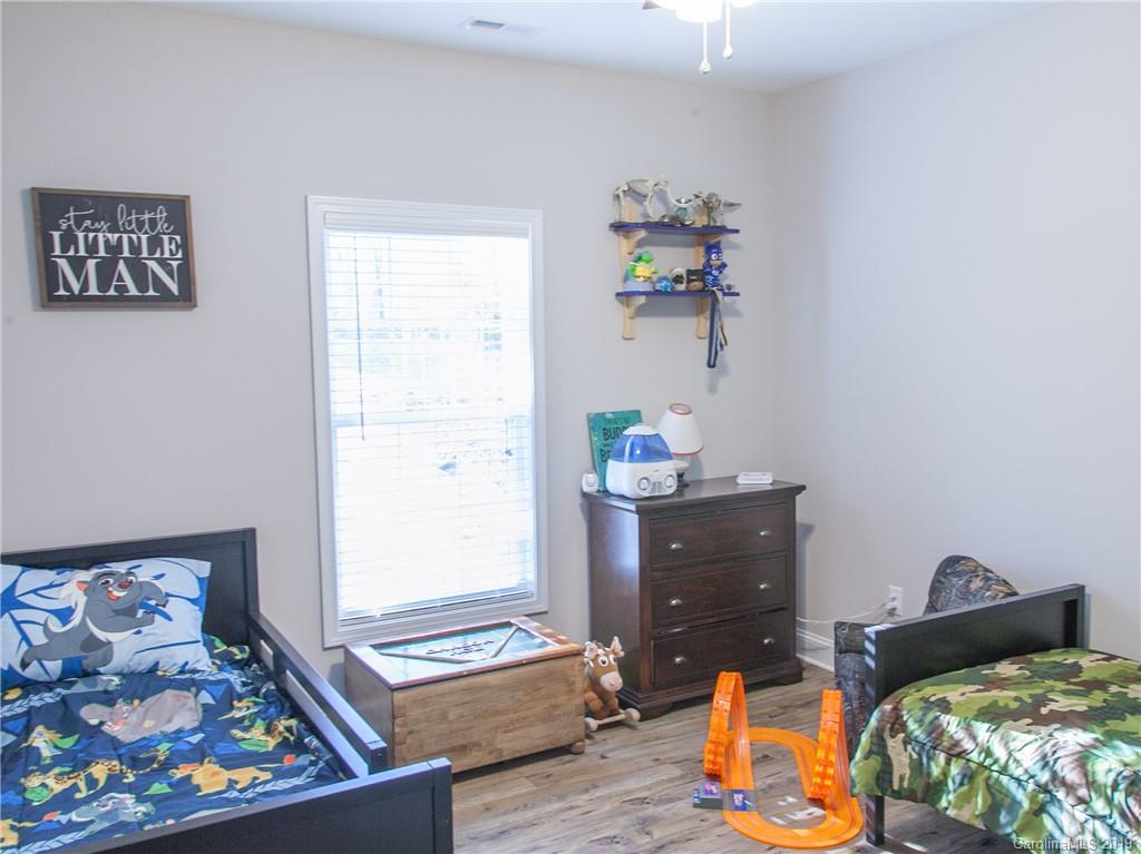 3018 Ranger Road, Unit 2B Clover, SC 29710 - Photo 19 of 23 a bed room with a bed and wooden floor