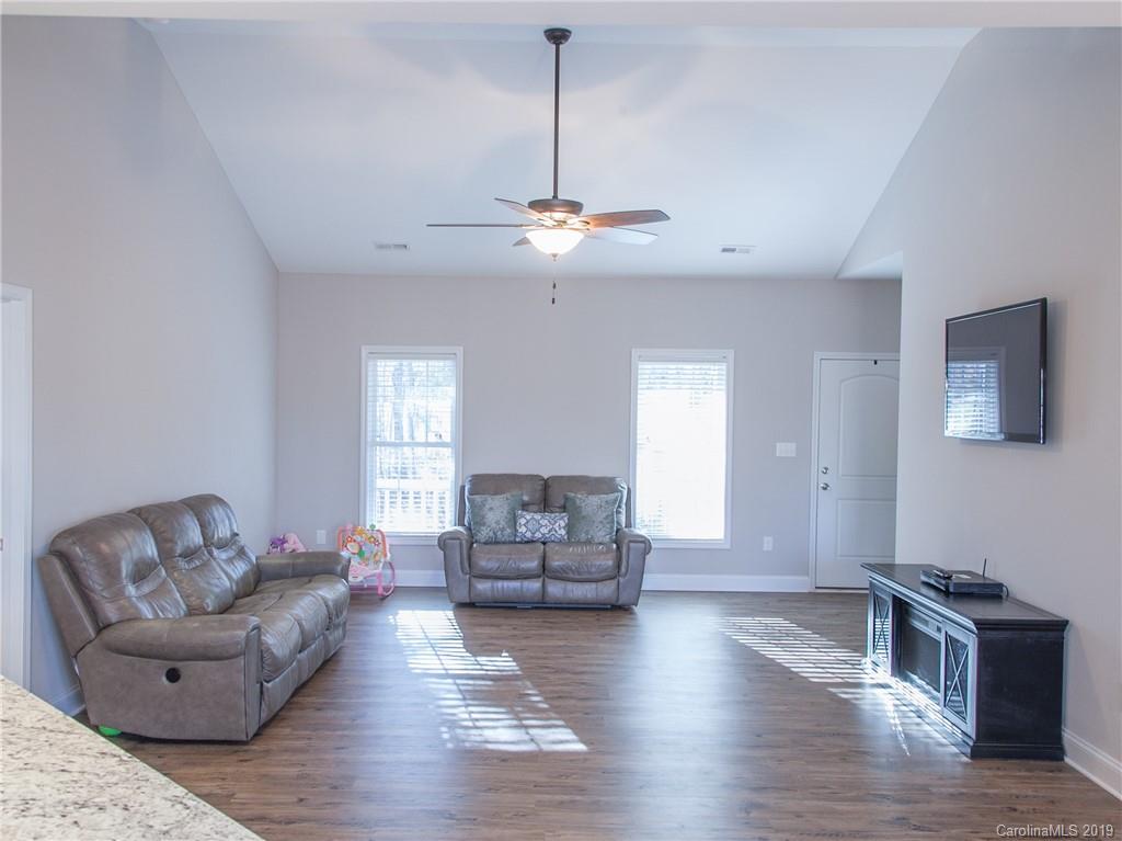 3018 Ranger Road, Unit 2B Clover, SC 29710 - Photo 6 of 23 a living room with furniture and a chandelier