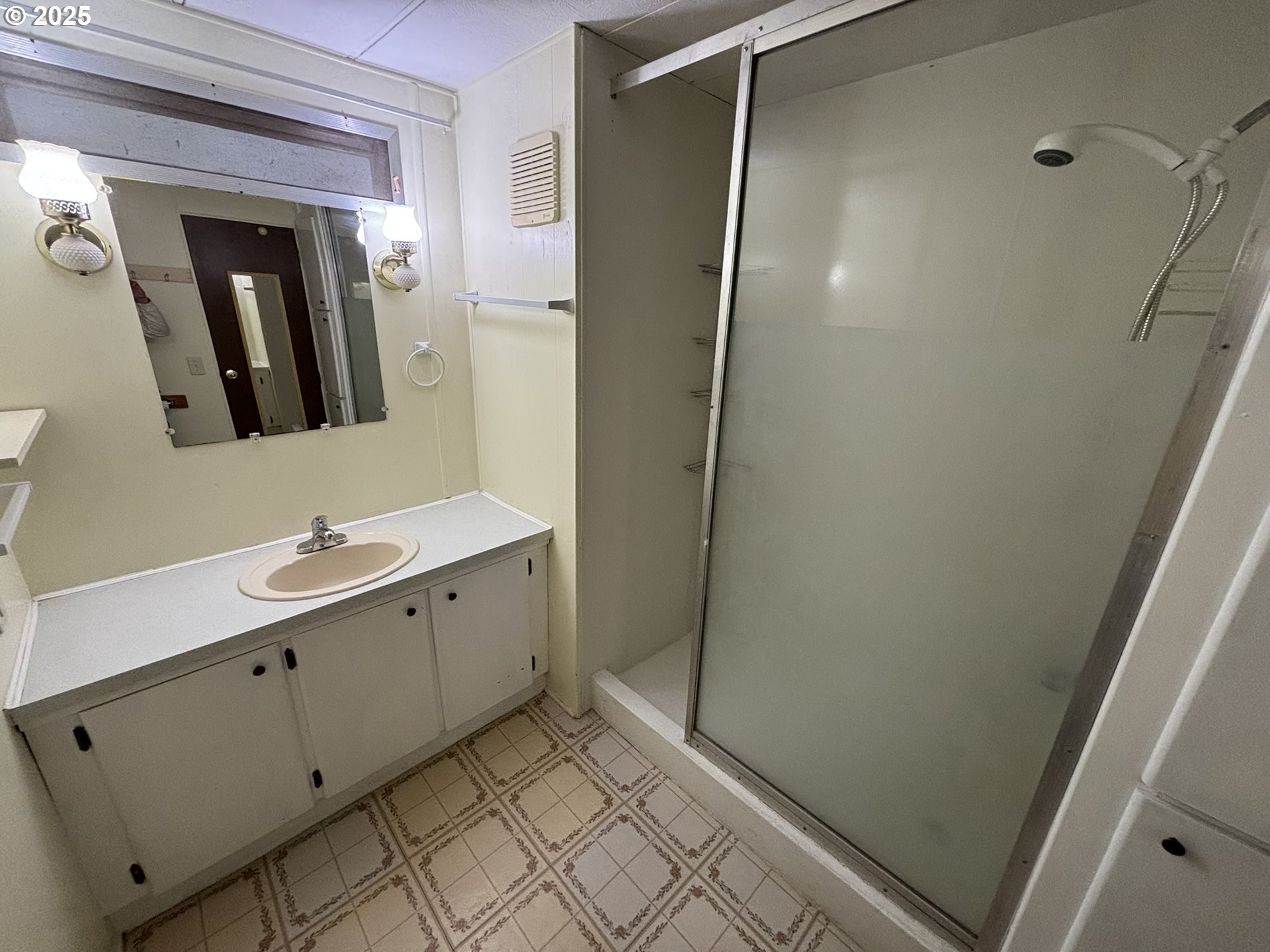 5336 Buckskin Bob Florence, OR 97439 - Photo 24 of 36 a bathroom with a double vanity sink and mirror