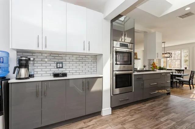 a kitchen with stainless steel appliances granite countertop a stove and more cabinets