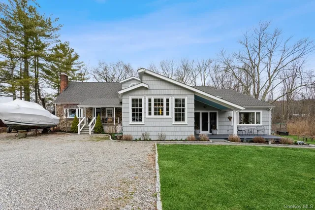 a front view of house with yard and outdoor seating