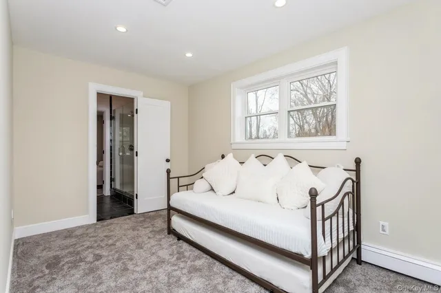 a spacious bedroom with a bed and a window