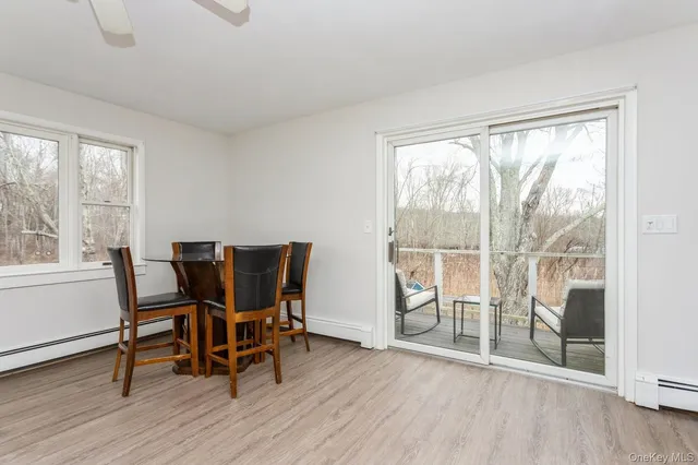 a view of a work space with wooden floor and a floor to ceiling window