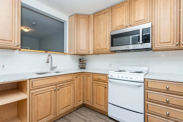 a kitchen with cabinets appliances and a sink