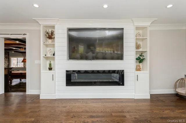 a living room with a flat screen tv and a fireplace