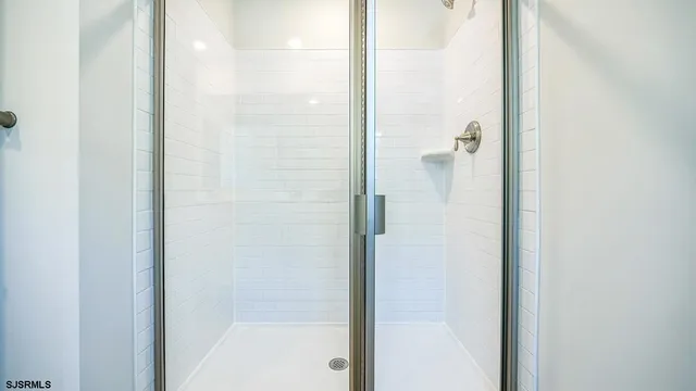 a bathroom with a glass shower door