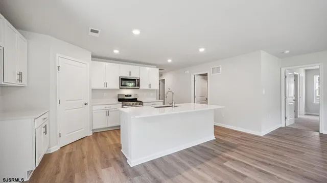 a view of kitchen with sink microwave and stove