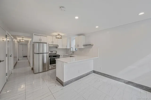 a kitchen with a refrigerator and a sink