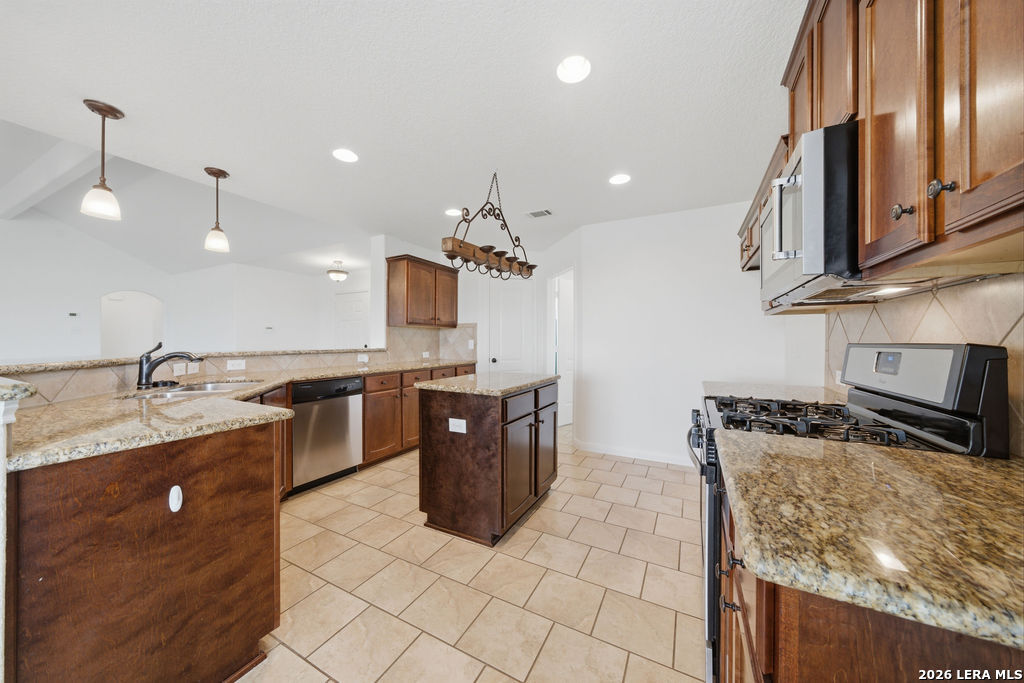 12897 La Vernia Road St. Hedwig, TX 78152 - Photo 9 of 34 a kitchen with stainless steel appliances granite countertop a sink stove and refrigerator