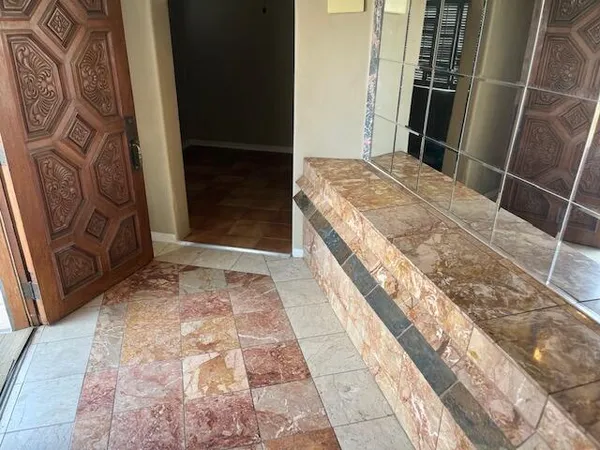 a bathroom with a granite countertop shower and a sink