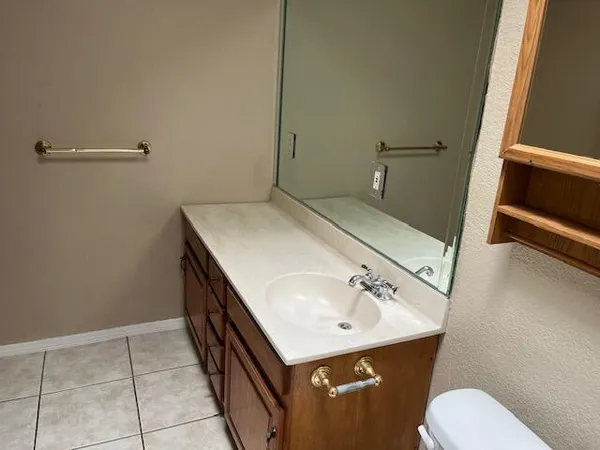 a bathroom with a sink toilet and vanity