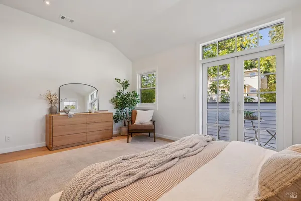 a bedroom with two beds and a window with outer view