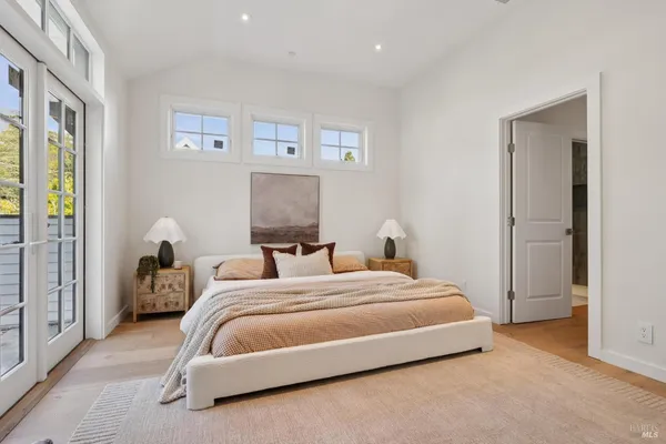 a bedroom with two beds and a potted plant