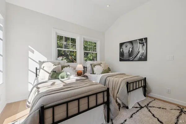 a bedroom with a large bed and a window