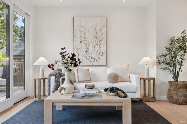 a living room with furniture and a floor to ceiling window