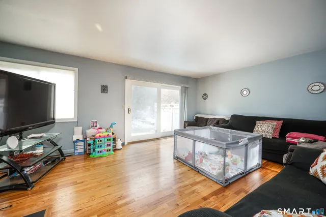 a view of a dining room with furniture and wooden floor