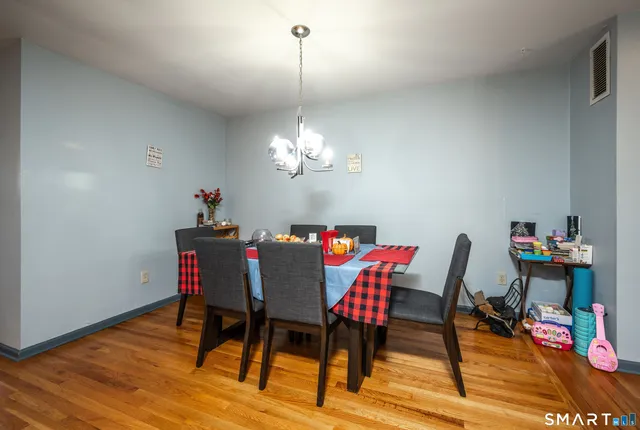 a living room with furniture a flat screen tv and a window
