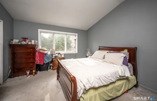 a bedroom with a bed and a mirror