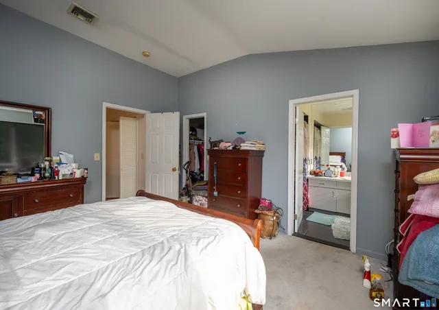 a bathroom with a sink vanity mirror and toilet