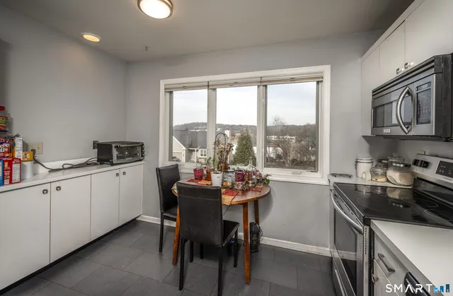 a kitchen with a stove a sink a microwave and cabinets