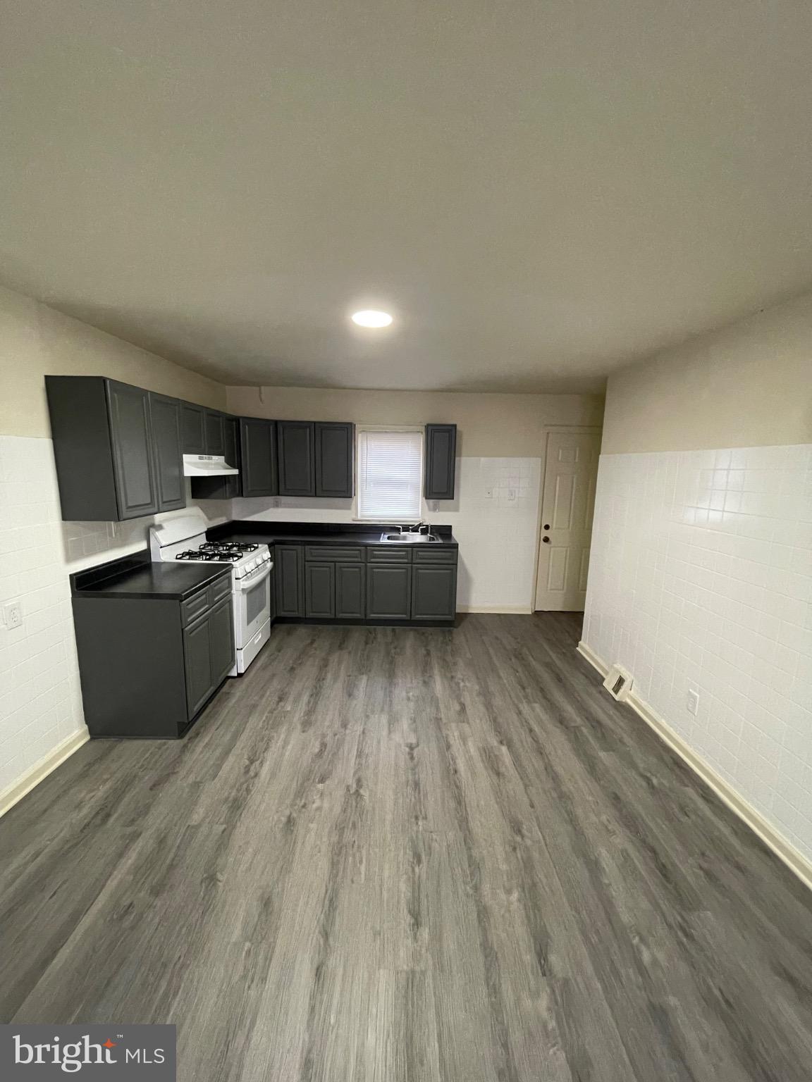 2441 North 5th Street Philadelphia, PA 19133 - Photo 2 of 19 a view of kitchen with wooden floor and electronic appliances