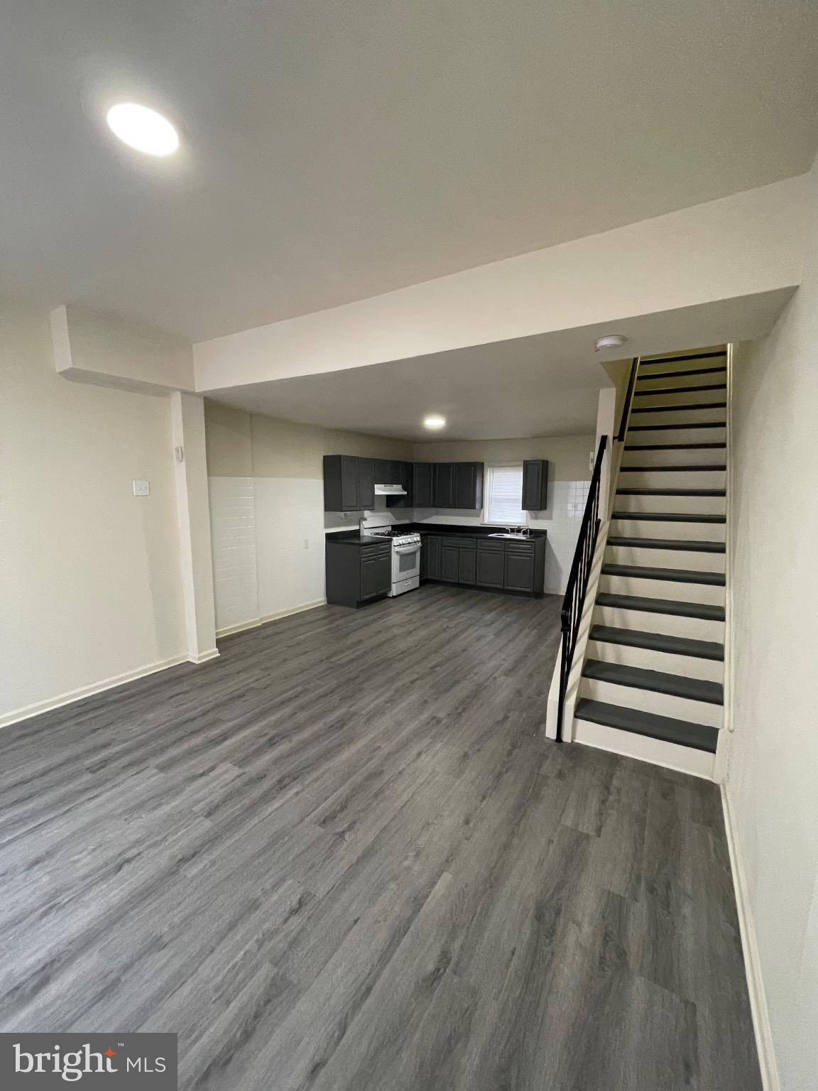 2441 North 5th Street Philadelphia, PA 19133 - Photo 6 of 19 a view of empty room with stairs and wooden floor