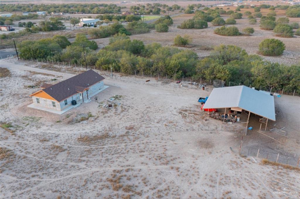 4 Mile 4 Road Penitas, TX 78576 - Photo 3 of 12 an aerial view of a house with yard and trees in the background