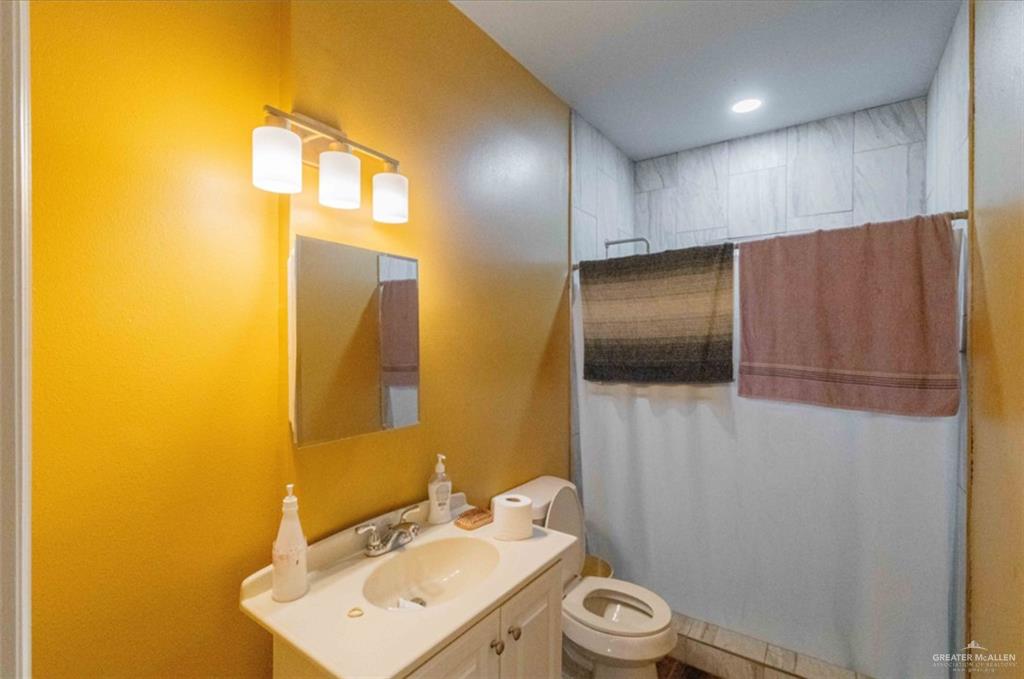 4 Mile 4 Road Penitas, TX 78576 - Photo 9 of 12 a bathroom with a sink a toilet and mirror