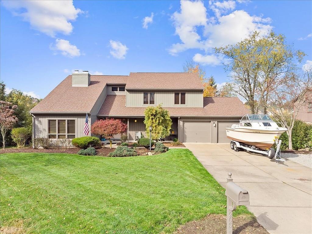 a white bench sitting in front of a house with a big yard