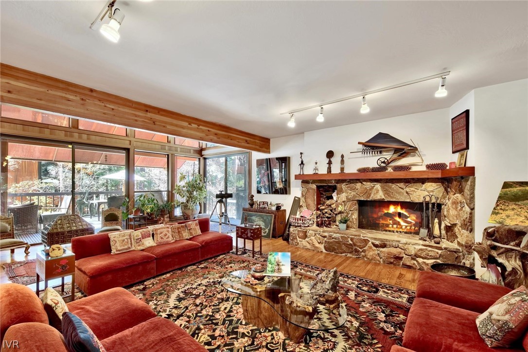 976 Tee Court Incline Village, NV 89451 - Photo 13 of 34 a living room with furniture a fireplace and large windows