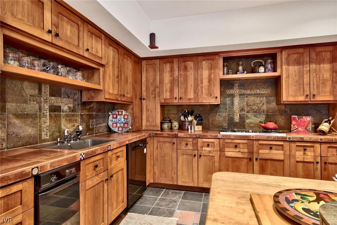 976 Tee Court Incline Village, NV 89451 - Photo 18 of 34 a kitchen with stainless steel appliances granite countertop a sink and cabinets