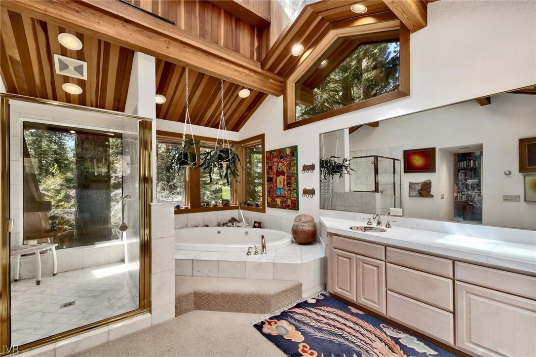 976 Tee Court Incline Village, NV 89451 - Photo 22 of 34 a bathroom with a double vanity sink a mirror and a bath tub