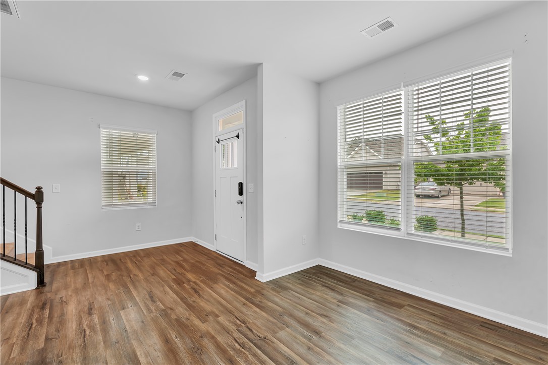 8 Leander Drive Greer, SC 29651 - Photo 12 of 31 Hardwood floors and generous windows illuminate this inviting entry and living area.