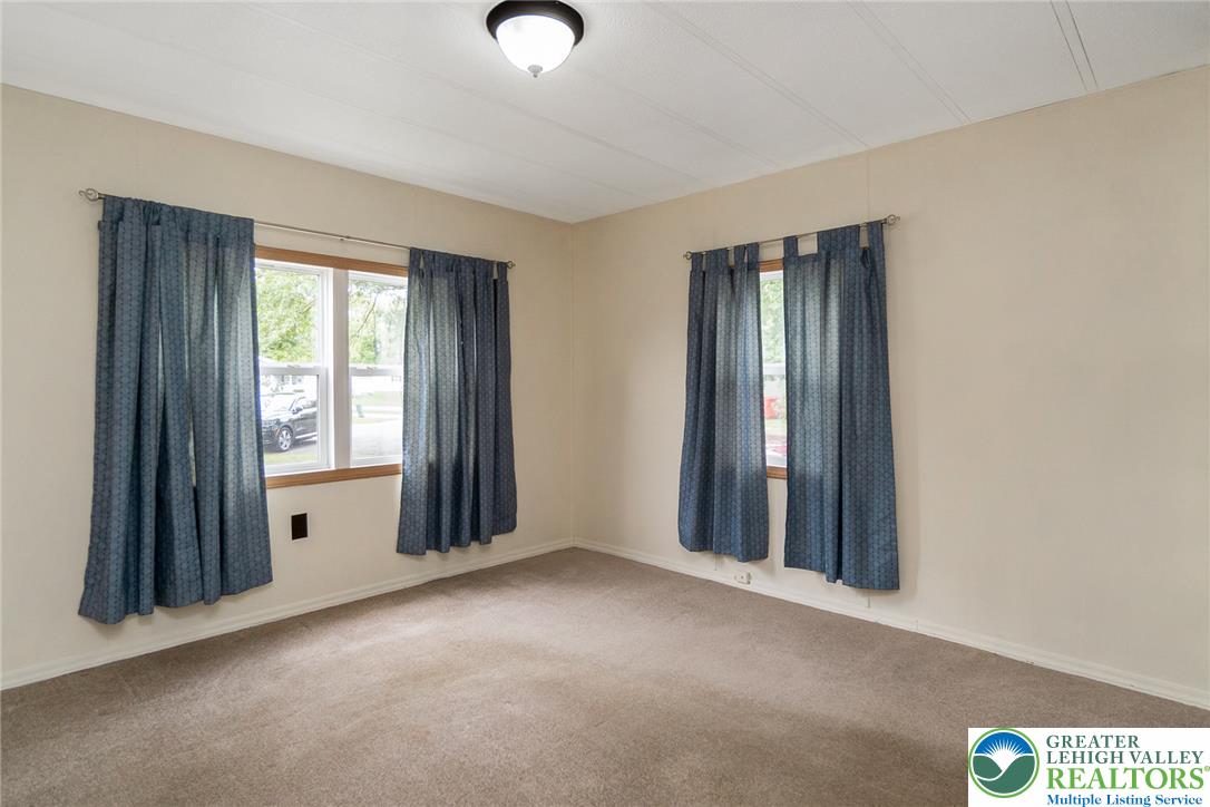 8721 Turkey Ridge Road Breinigsville, PA 18031 - Photo 27 of 30 Plentiful natural light streams through multiple windows in this cozy carpeted space.