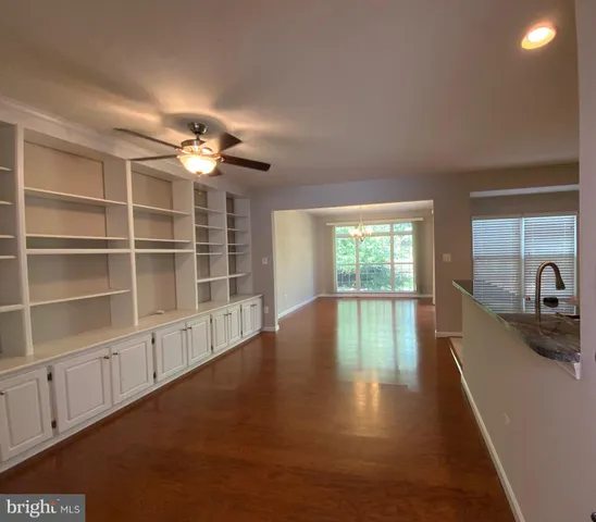 a kitchen with granite countertop wooden cabinets and stainless steel appliances