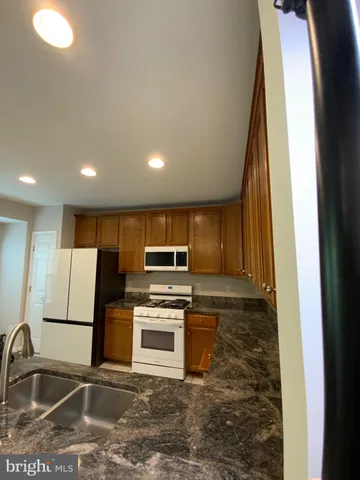 a kitchen with a refrigerator sink and microwave